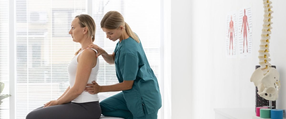young-physiotherapist-helping-patient-with-back-problems